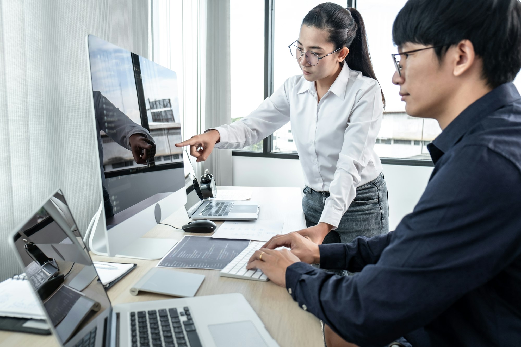 Team of two professional programmers working on website projects in software development